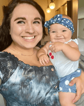 Baby girl is wearing a polka dot head wrap for little girls from By Bella Boutique.